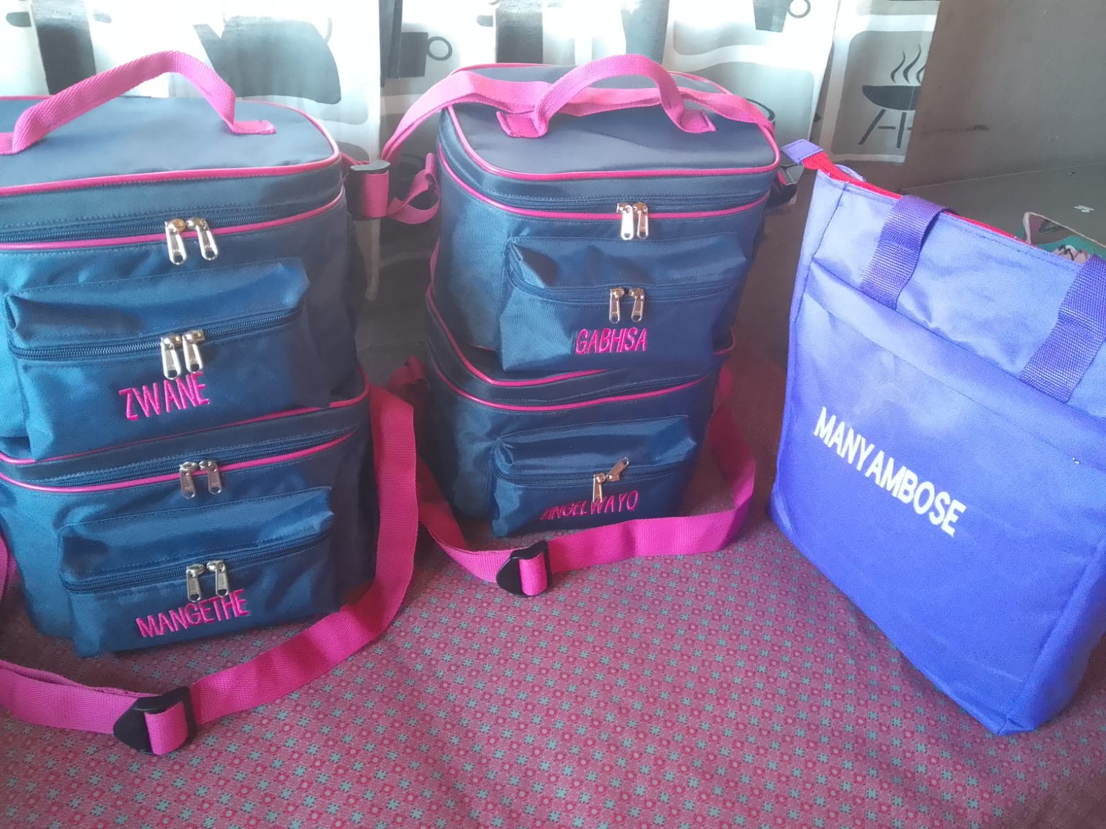 Blue and pink school bags with names